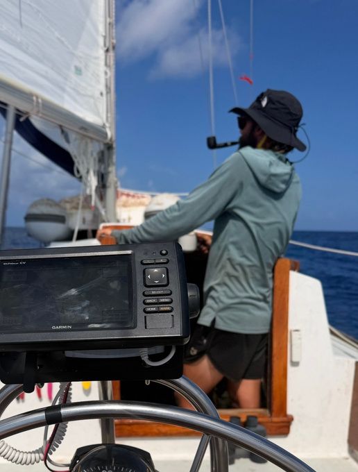 Dillon at the helm checking the chartplotter offshore